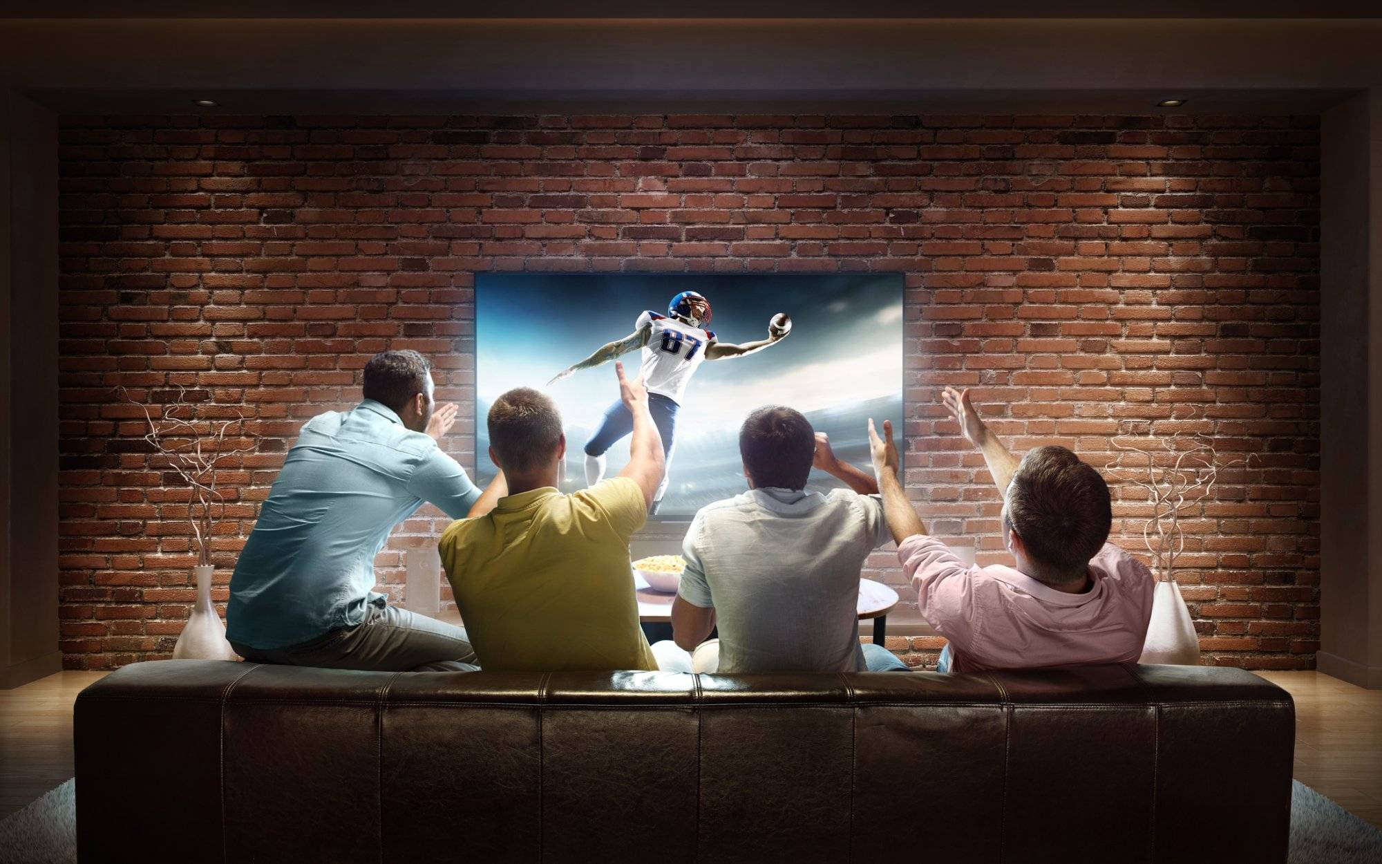 Students watching American football game at home Students watching American football game at home